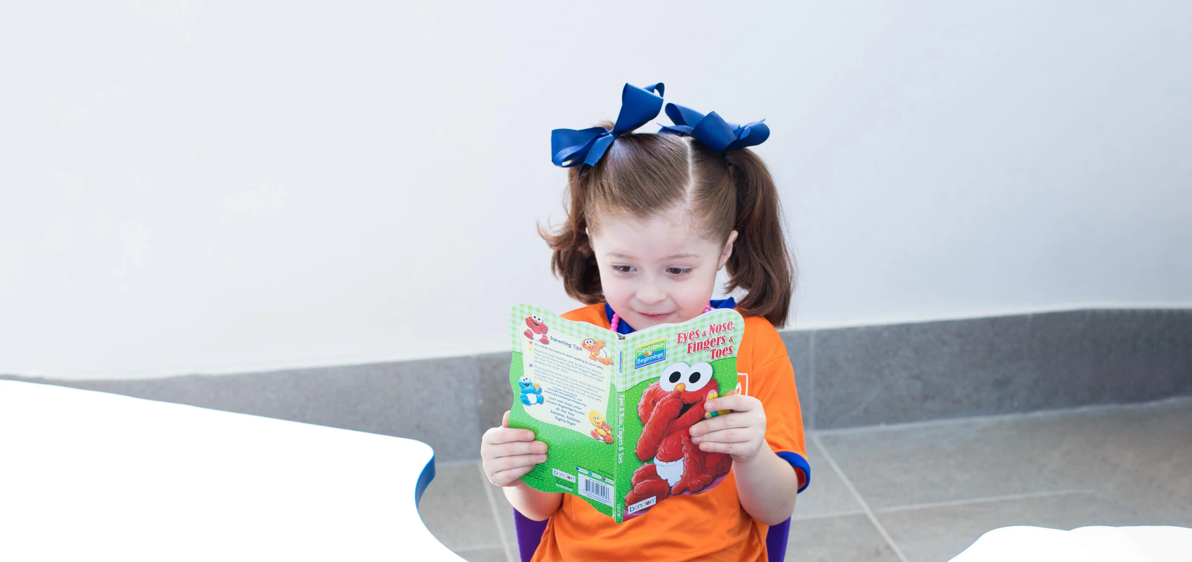 Instituto San Gerardo girl reading a book with curiosity