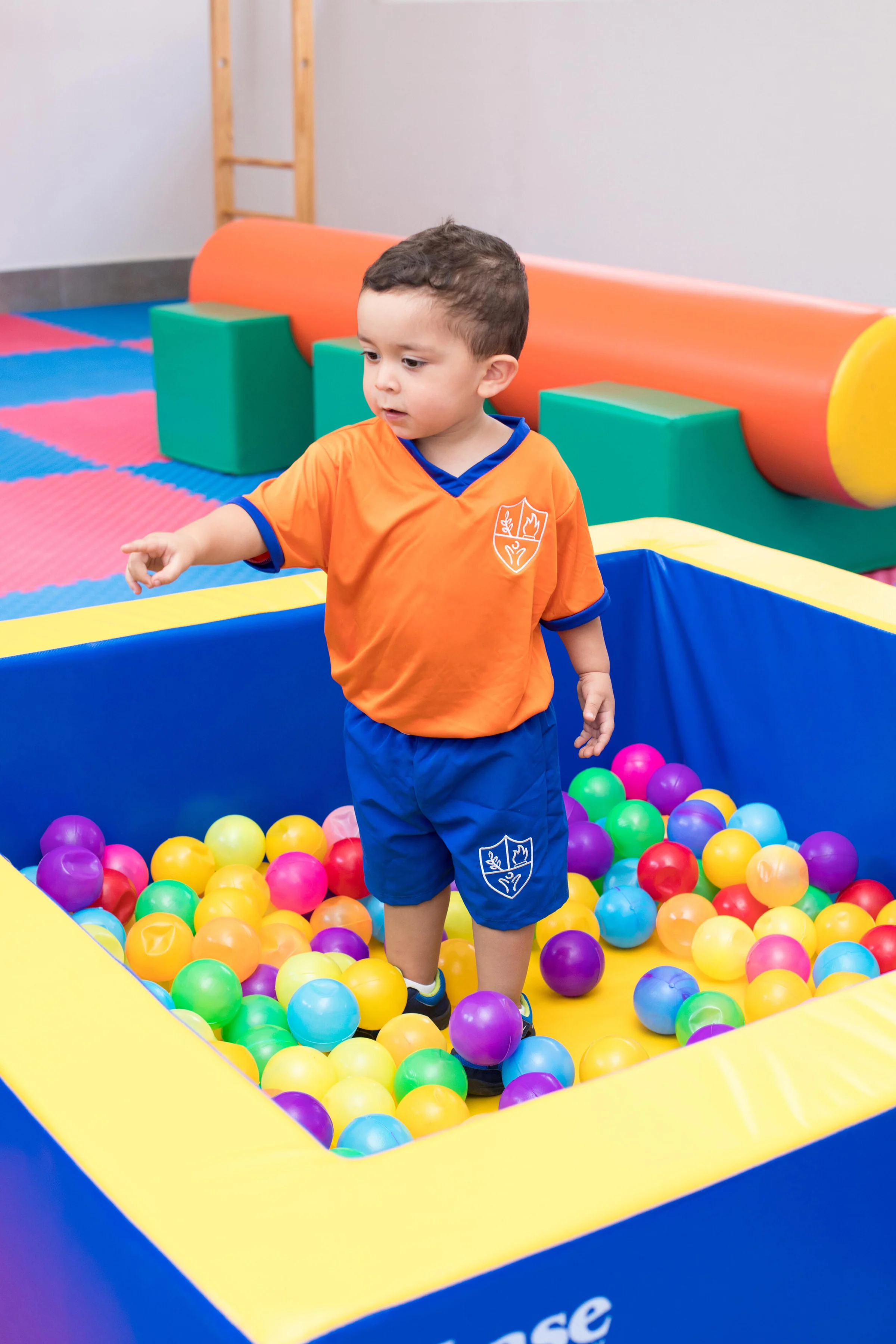 Instituto San Gerardo boy pointing at something in the campus play area