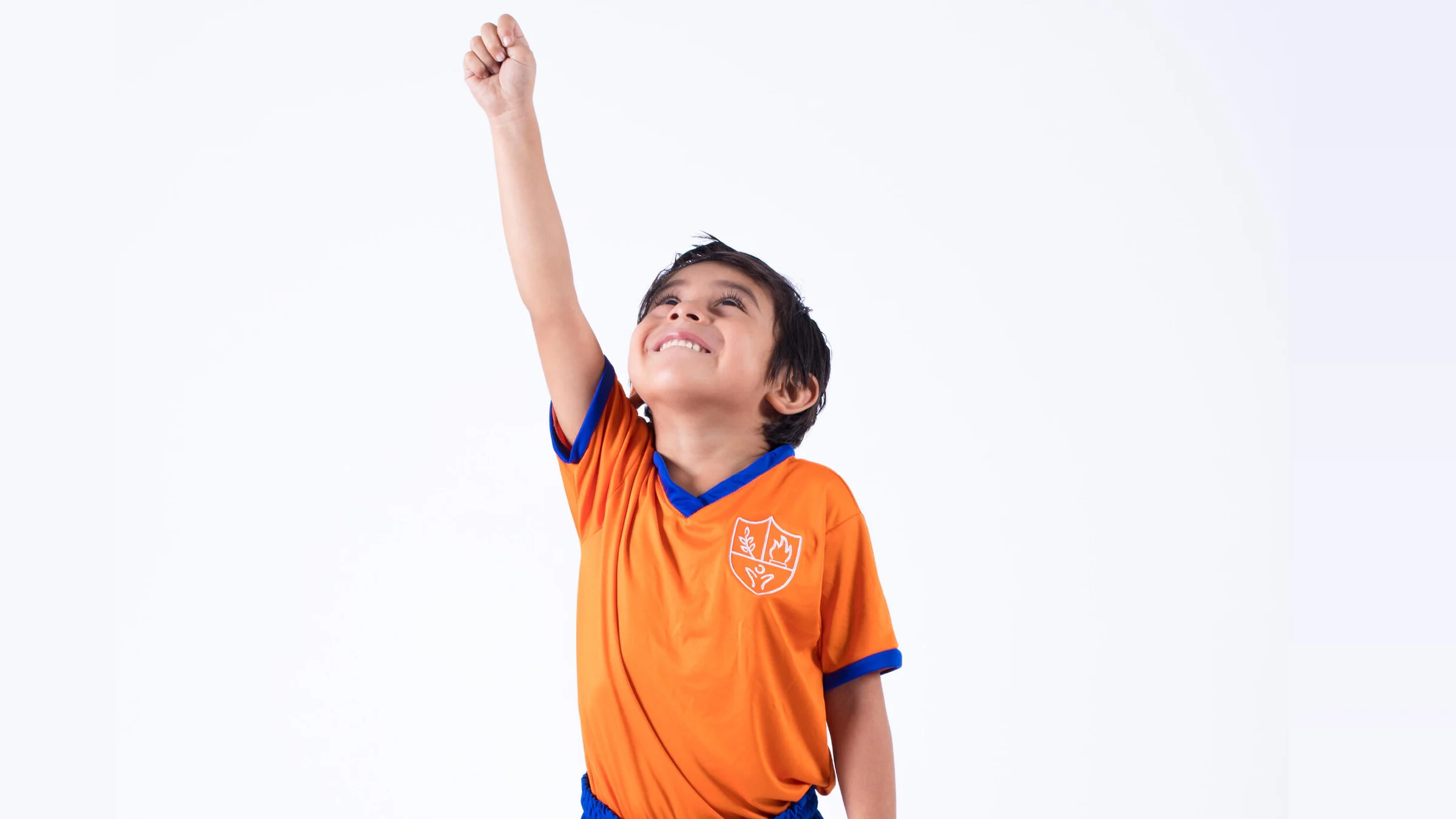 Instituto San Gerardo boy raising his fist and looking up with a smile