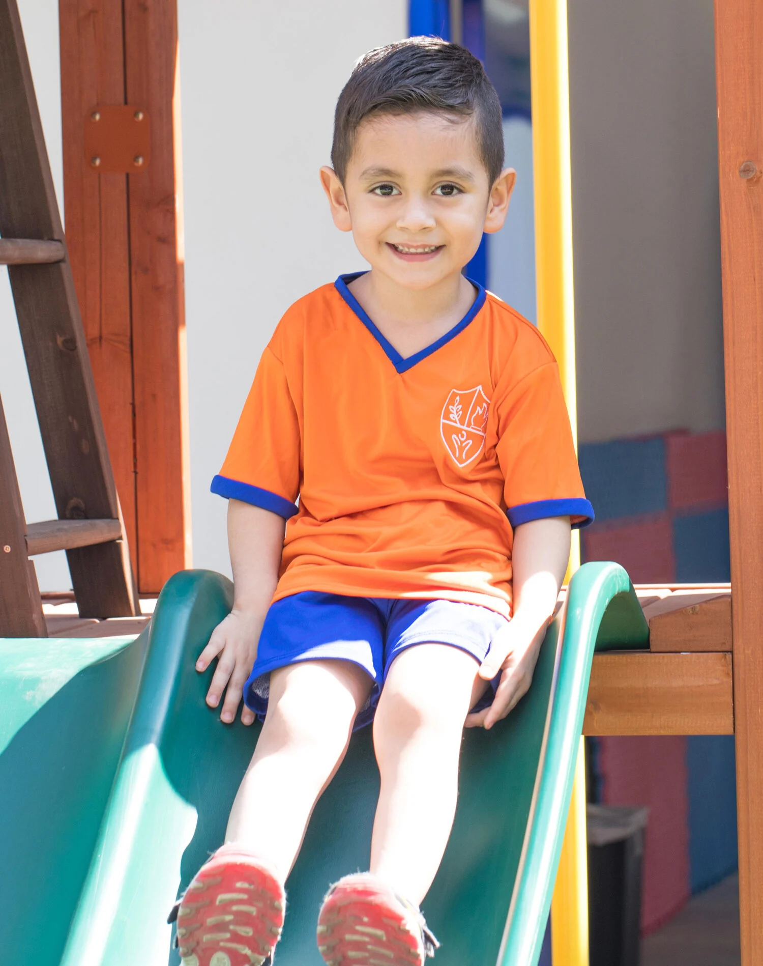Smiling elementary student on a slide
