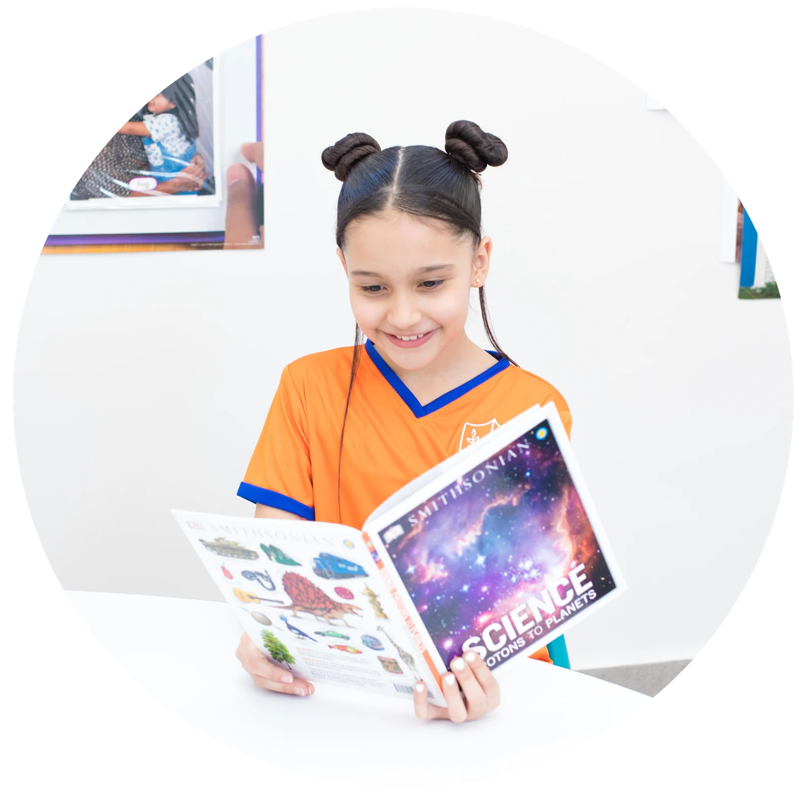 Elementary school girl reading a science book