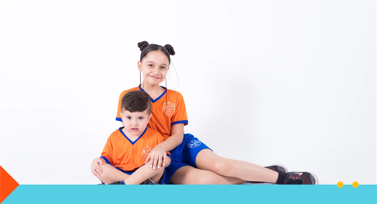 A girl and a boy from Instituto San Gerardo sitting together in their school uniforms